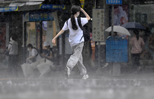 소나기가 내린 12일 오후 창원대학교 앞에서 한 시민이 황급히 뛰어가고 있다./김승권 기자/