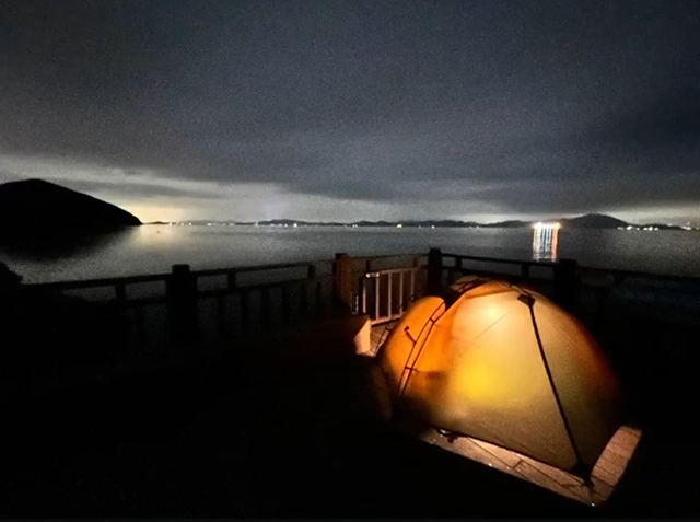 백패커의 텐트 불빛이 밤바다와 어우러져 운치를 더하고 있다.